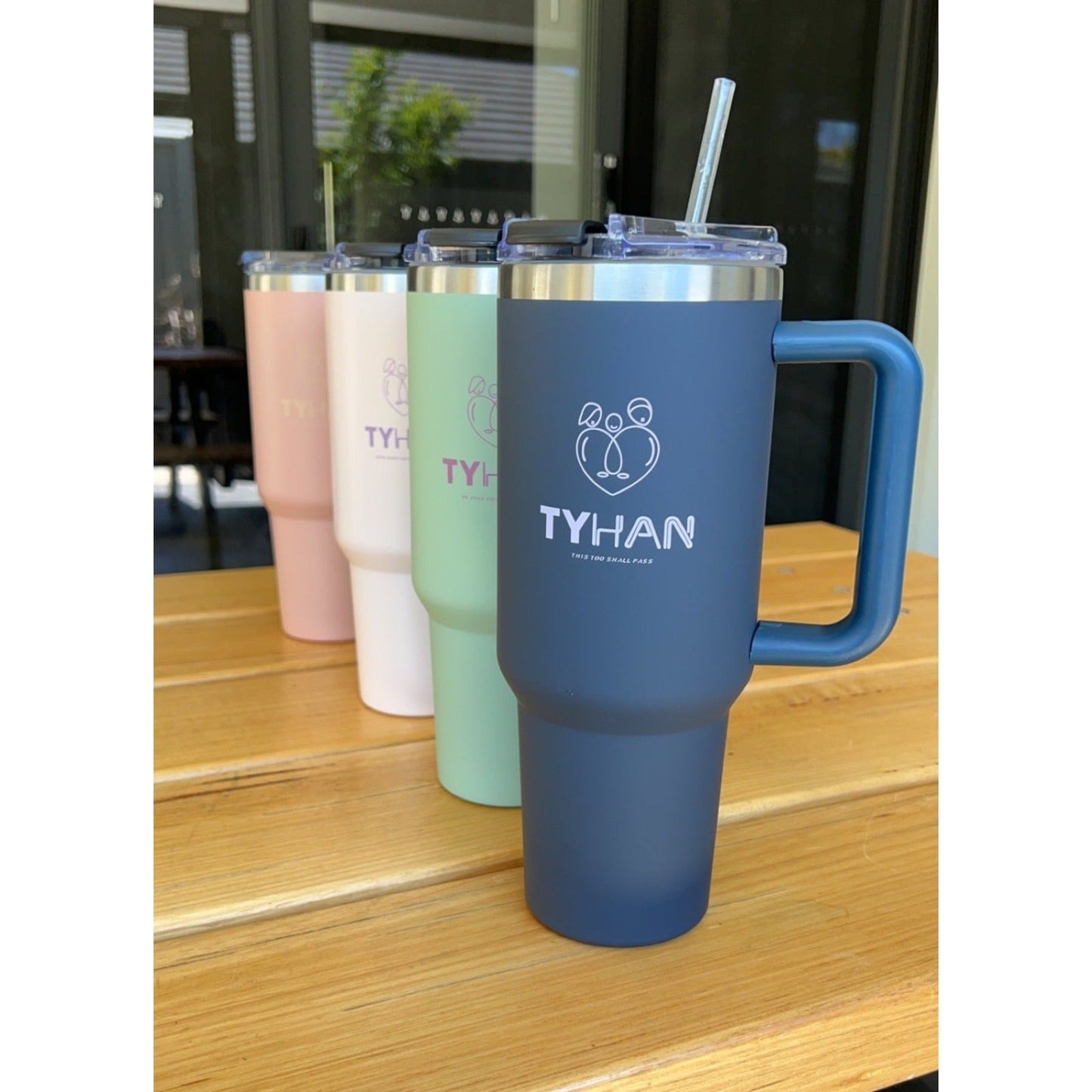 Image of four insulated drink bottles with straw and handle that are perfect for breastfeeding mothers.