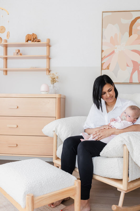 Mum sitting on her nursing chair with baby after a breastfeeding session